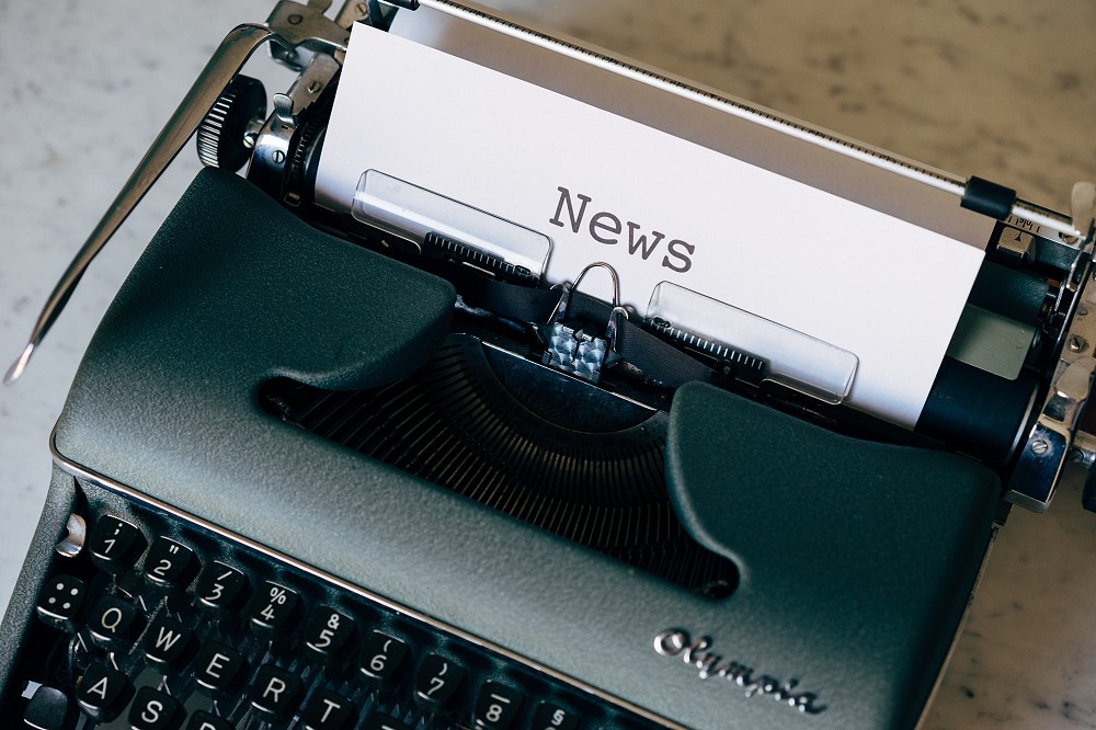 A typewriter that has printed the word News